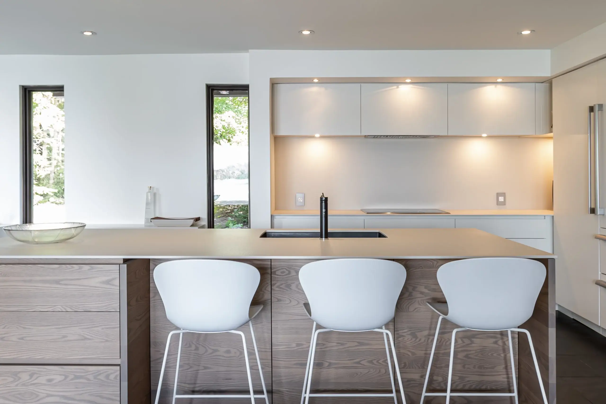 View of a kitchen and island with lighting