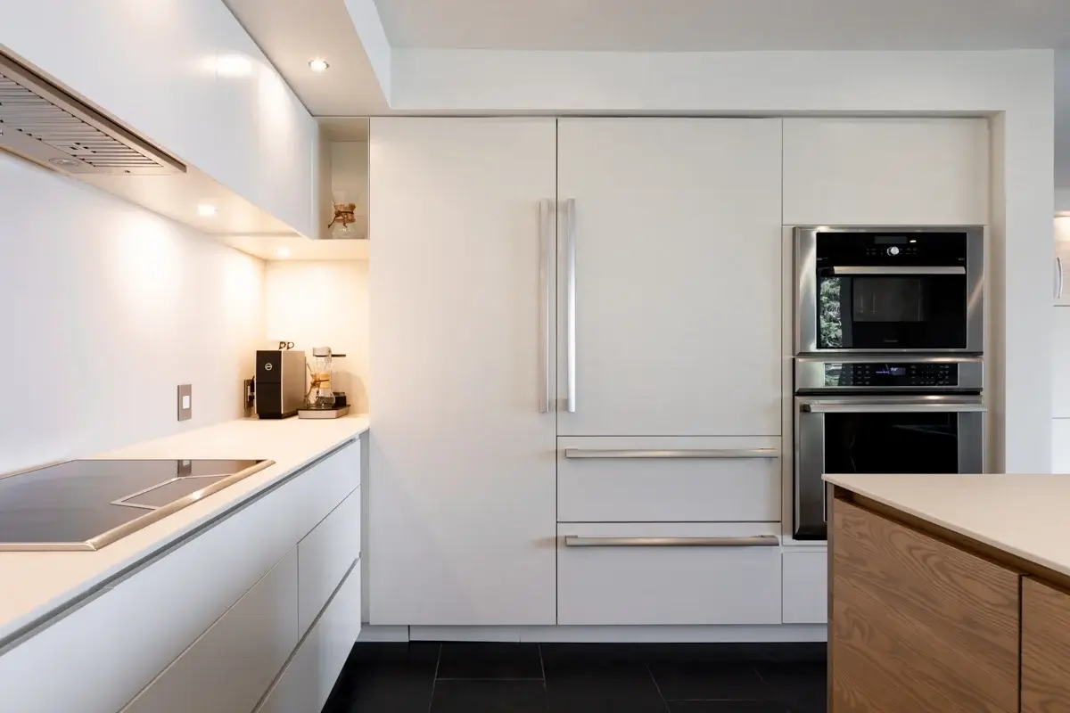 View of a kitchen with a panel-covered electrical panel