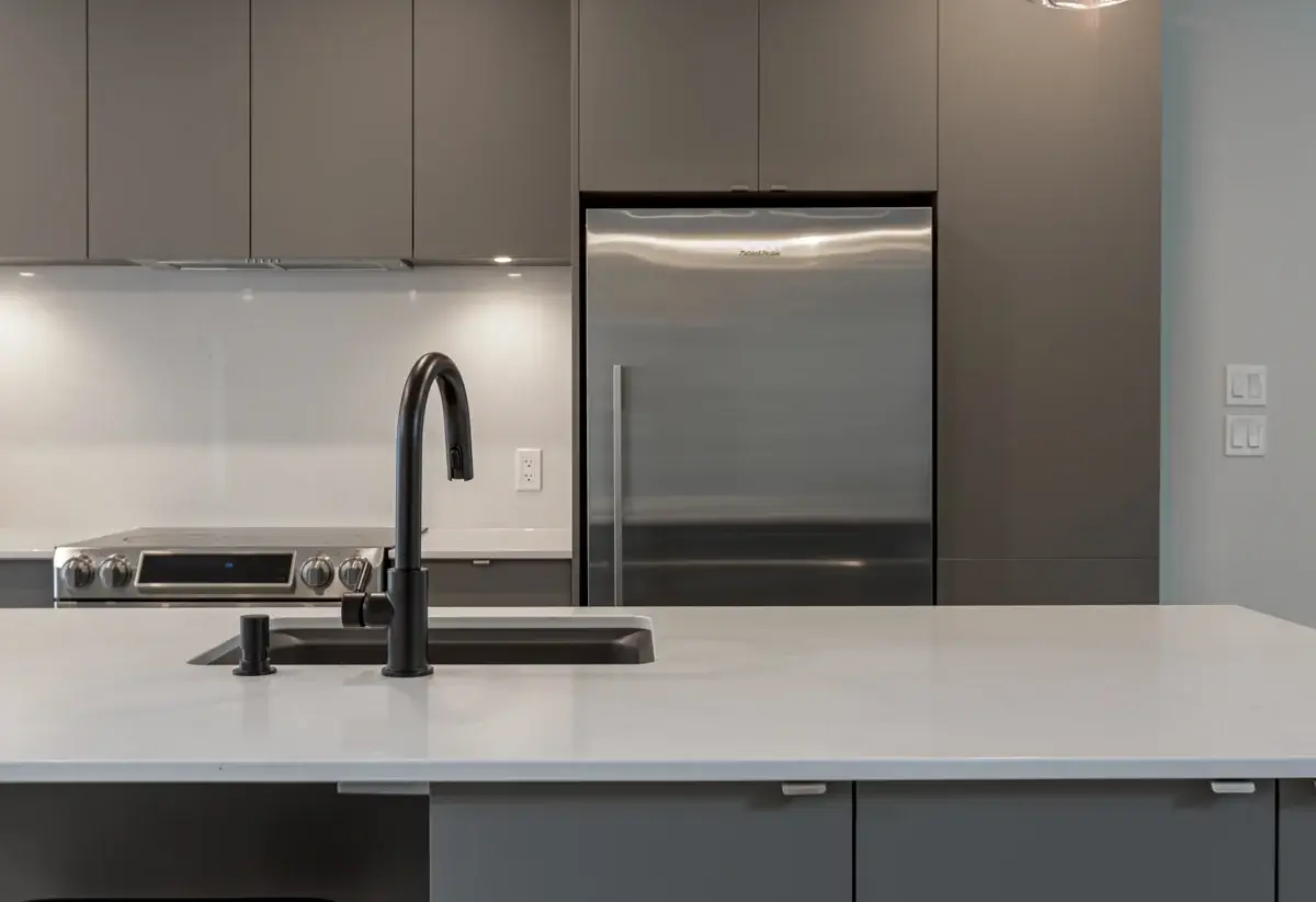 View of faucet on island with kitchen cabinet