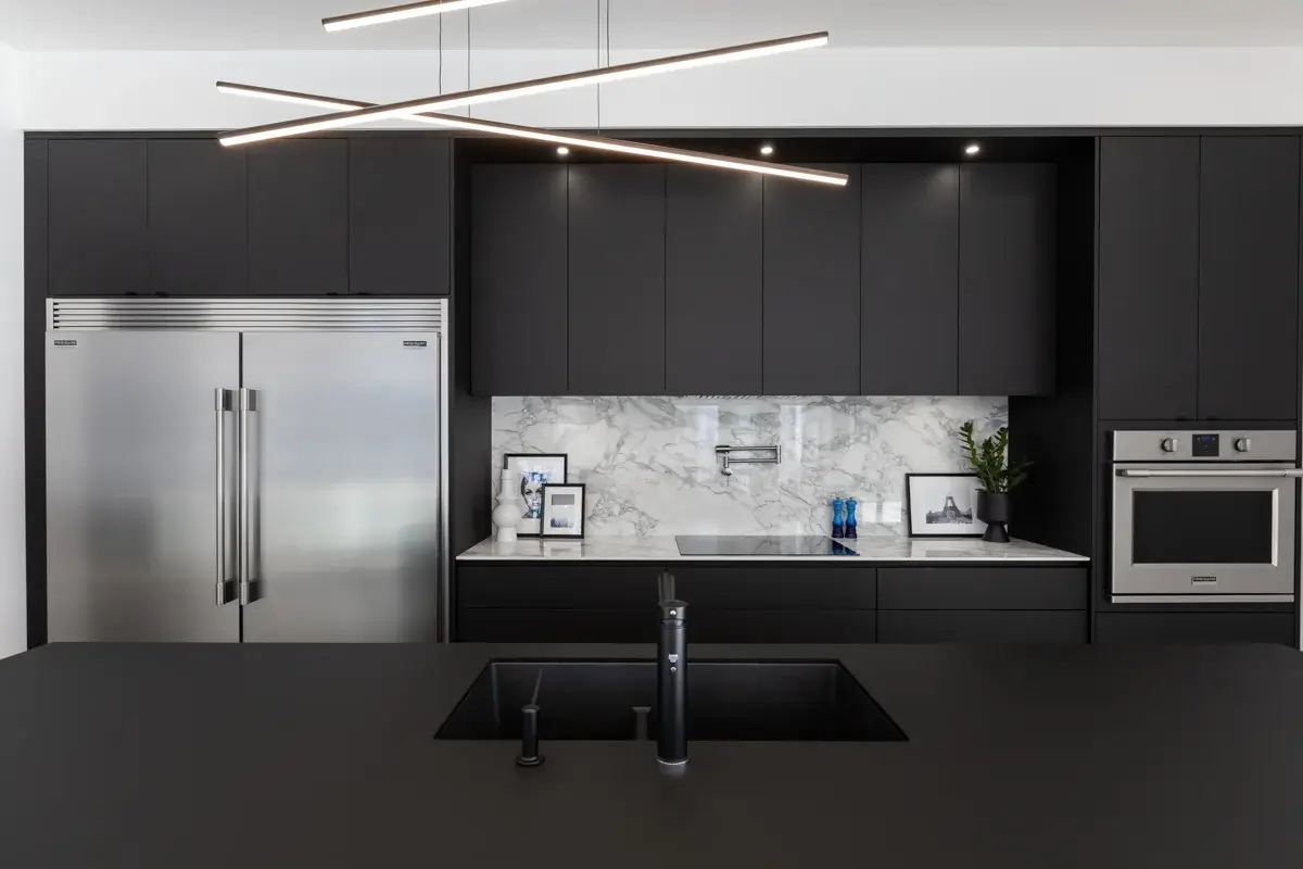 View of a monochrome kitchen with central island